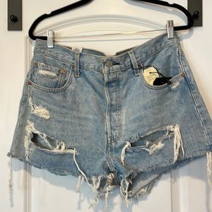 Light wash denim shorts with fraying and tears